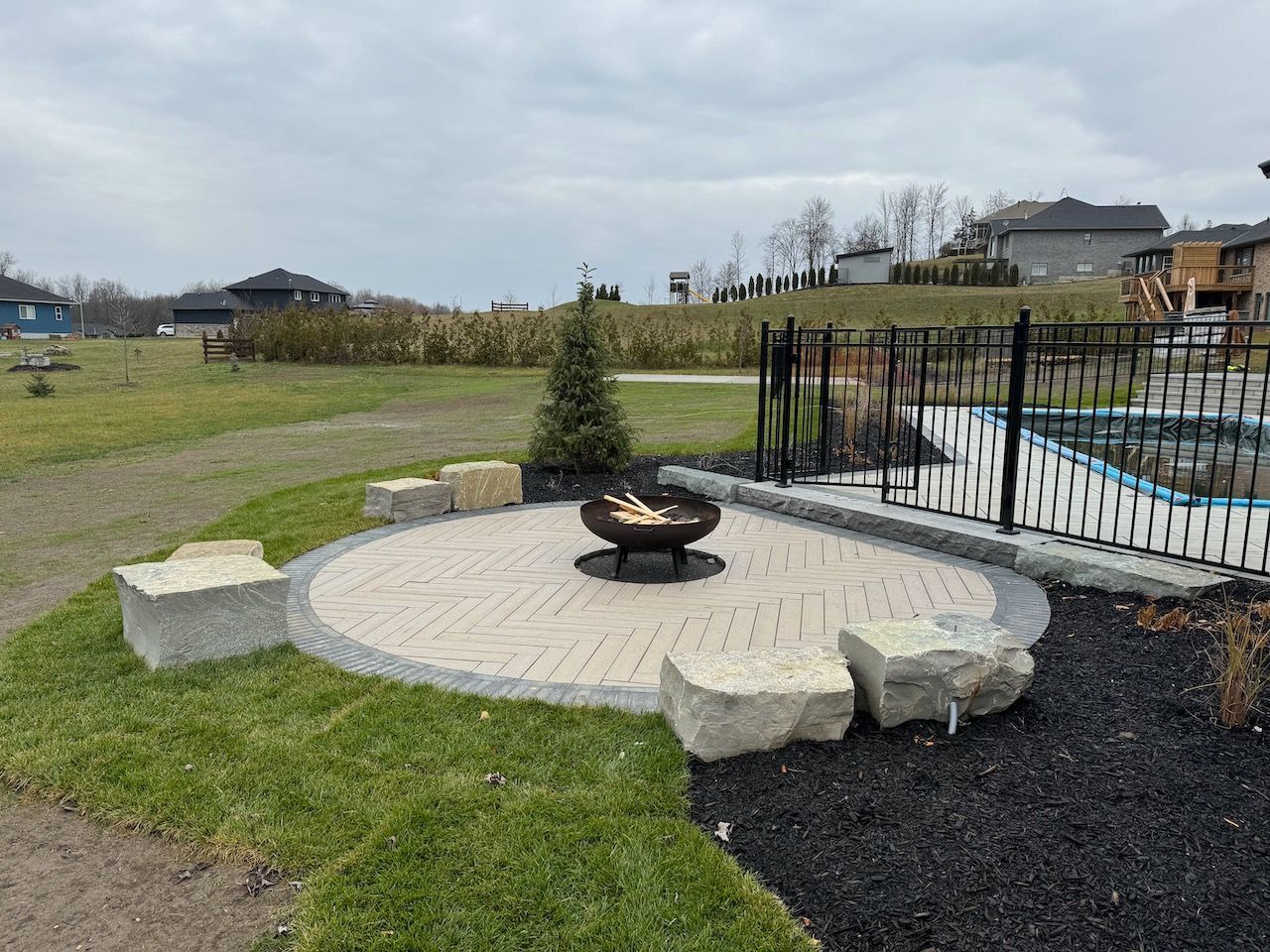 There is a fire pit in the middle of the yard.