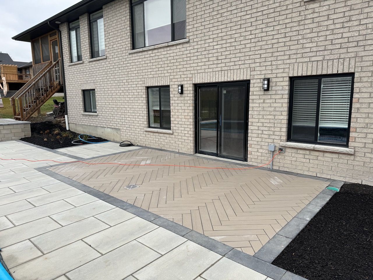 A brick house with a patio in front of it.