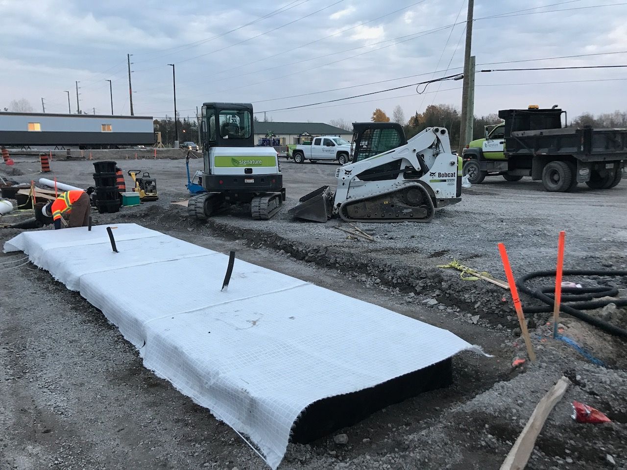 A construction site with a bulldozer and a dump truck.