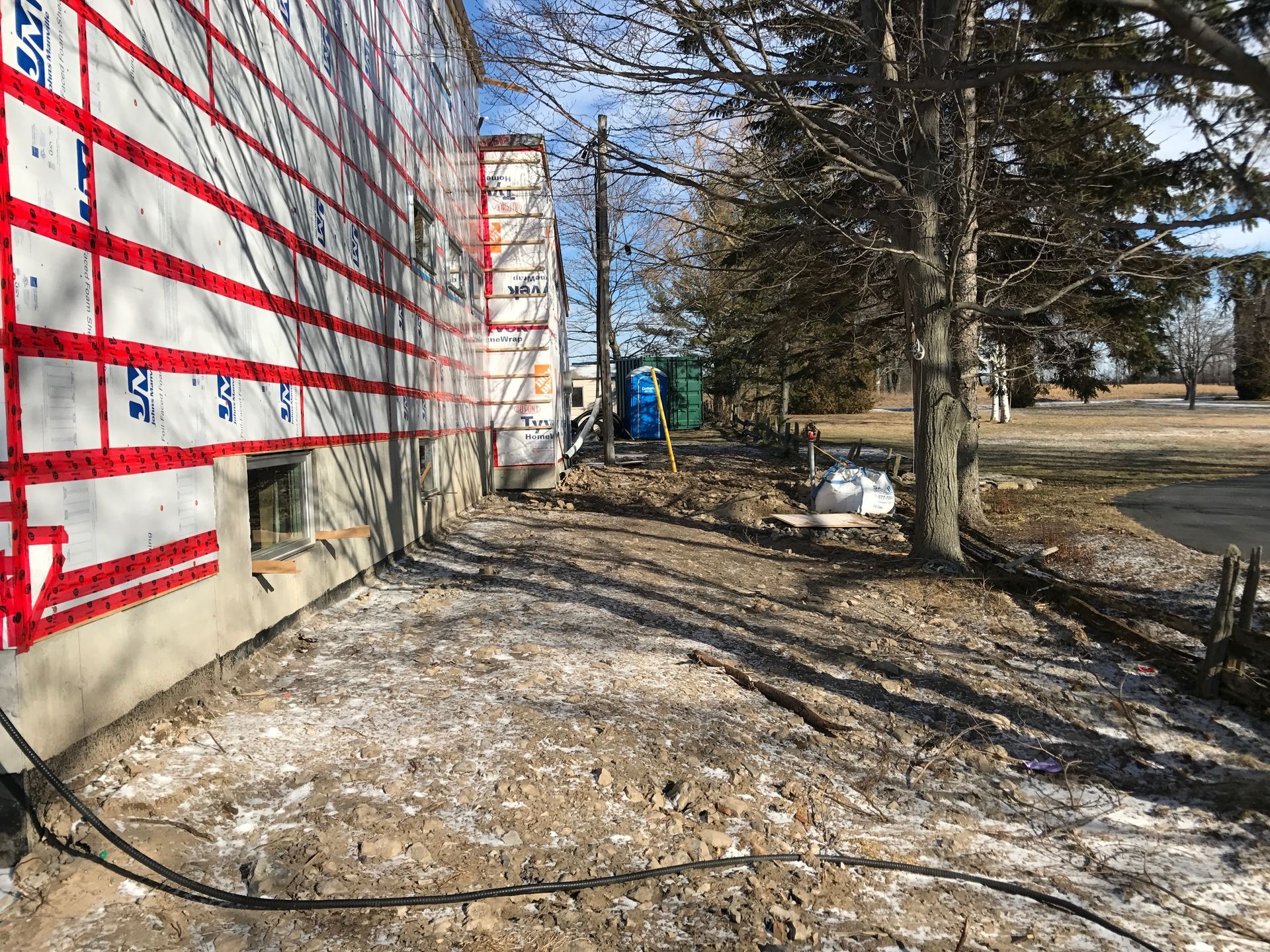 A building is being built in the middle of a dirt field.