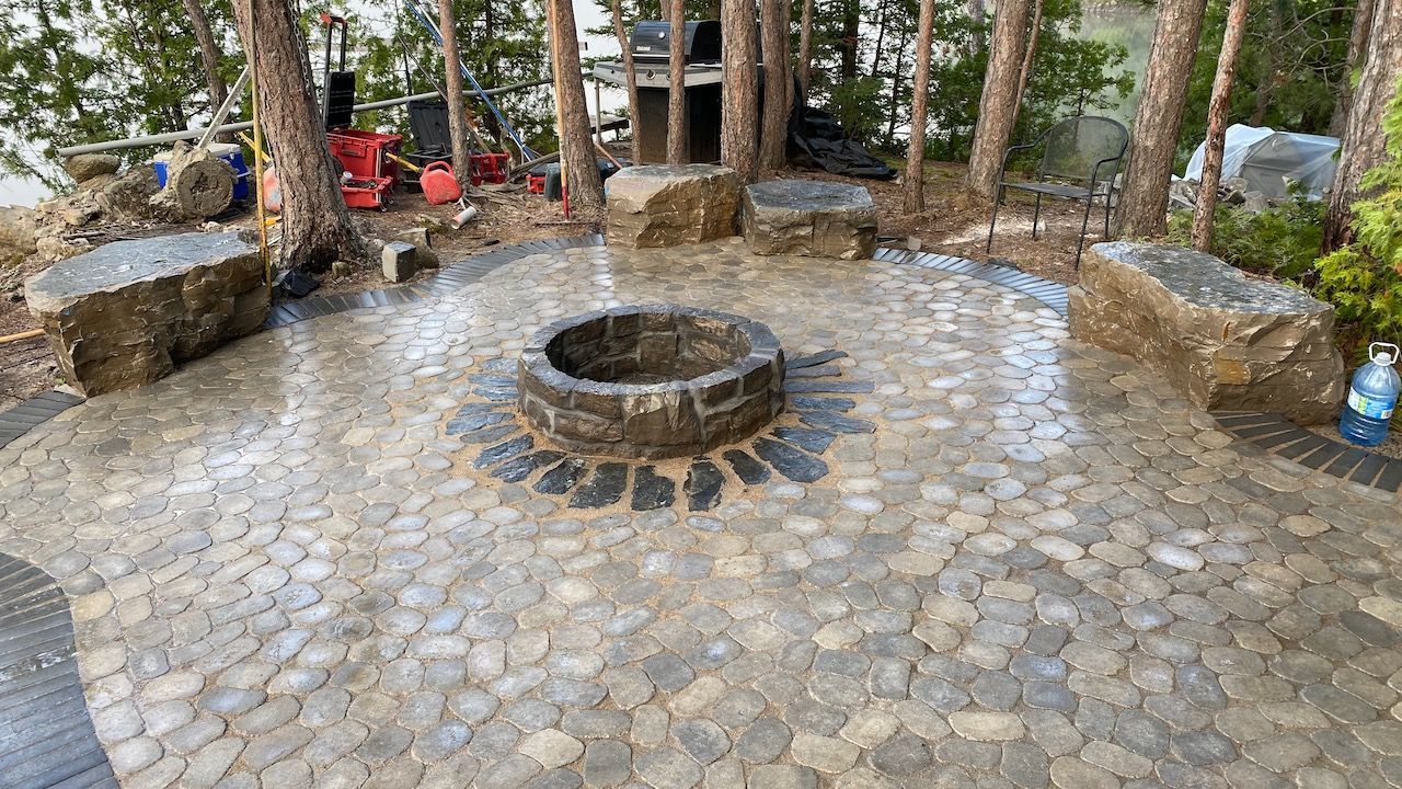 There is a fire pit in the middle of the patio.