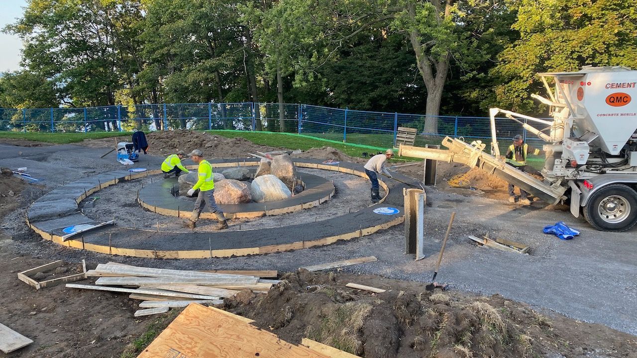 A group of construction workers are working on a concrete project.