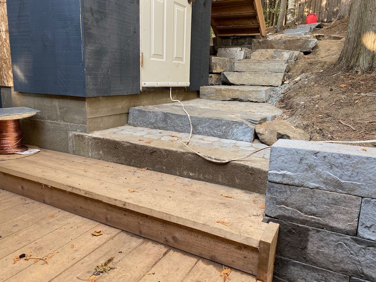 A wooden deck with stairs leading up to a house.