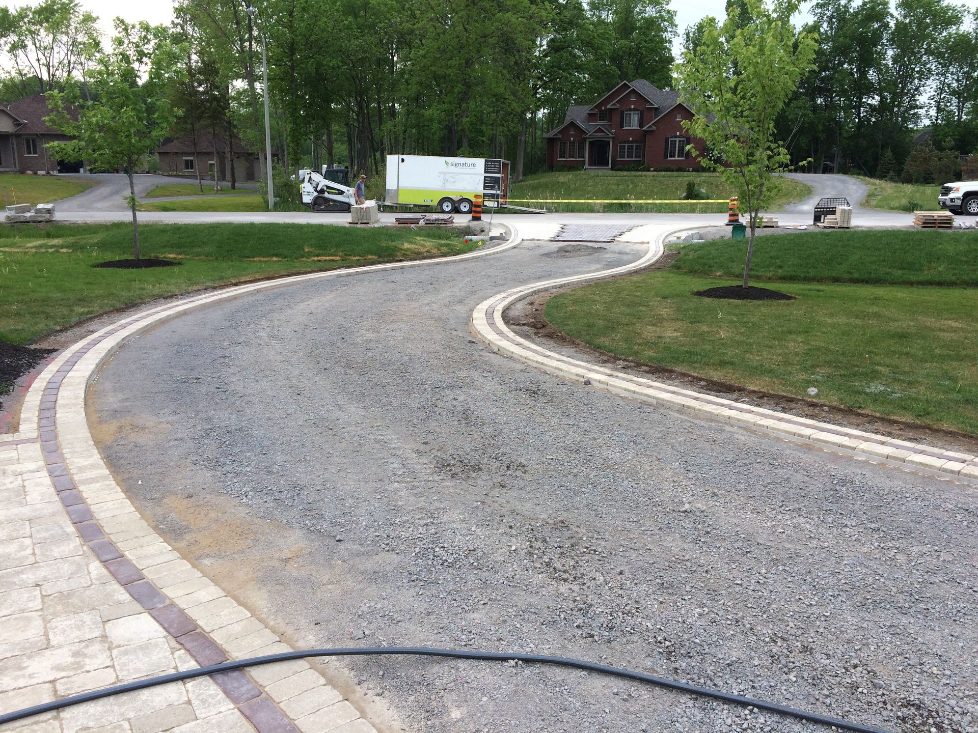 A curvy road with a hose on the side of it