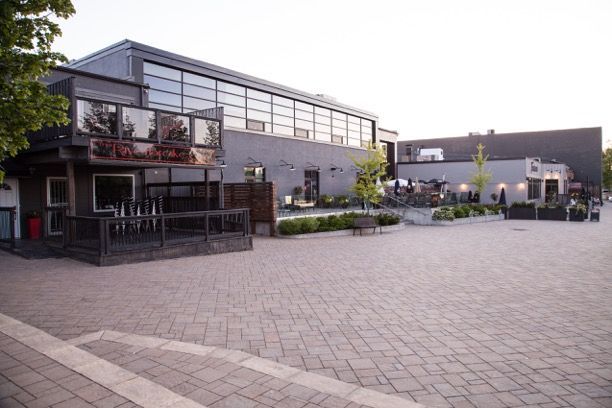 A large building with a brick walkway in front of it