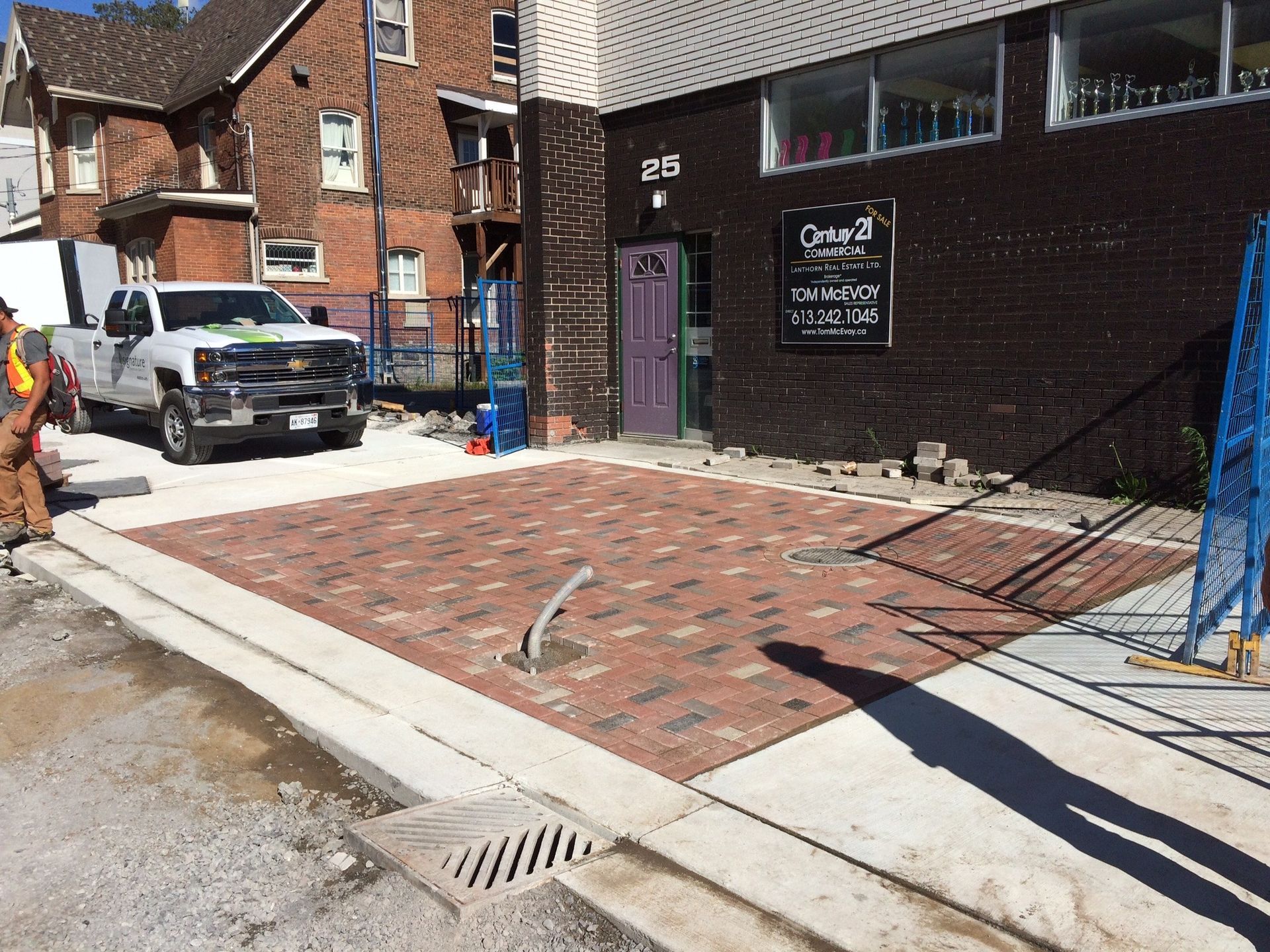 A white truck is parked in front of a brick building.