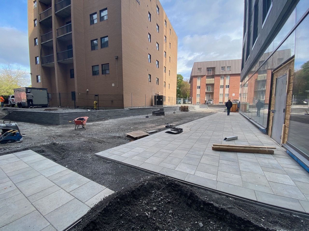 A construction site with a large building in the background.