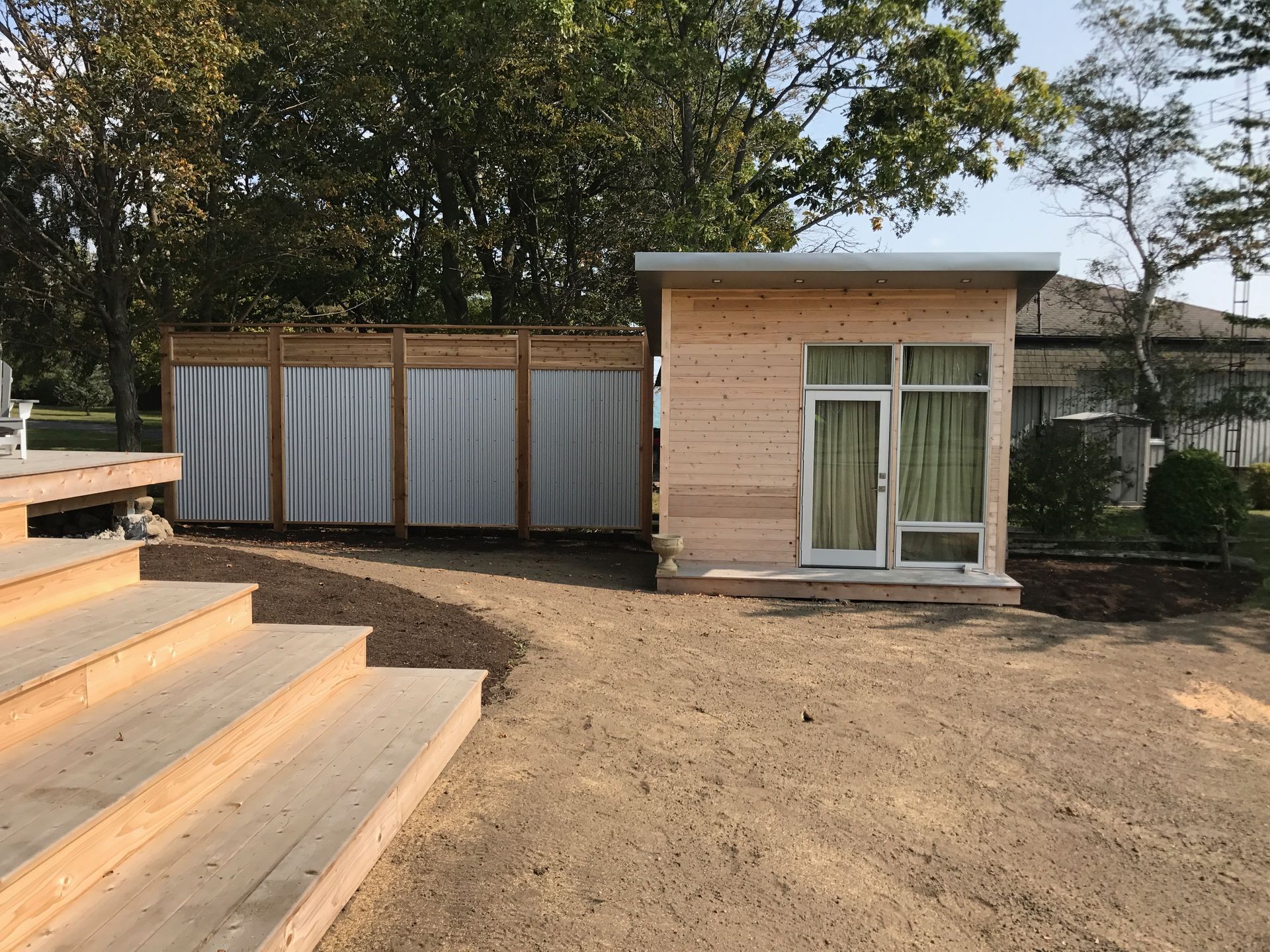 A small wooden house with stairs leading up to it