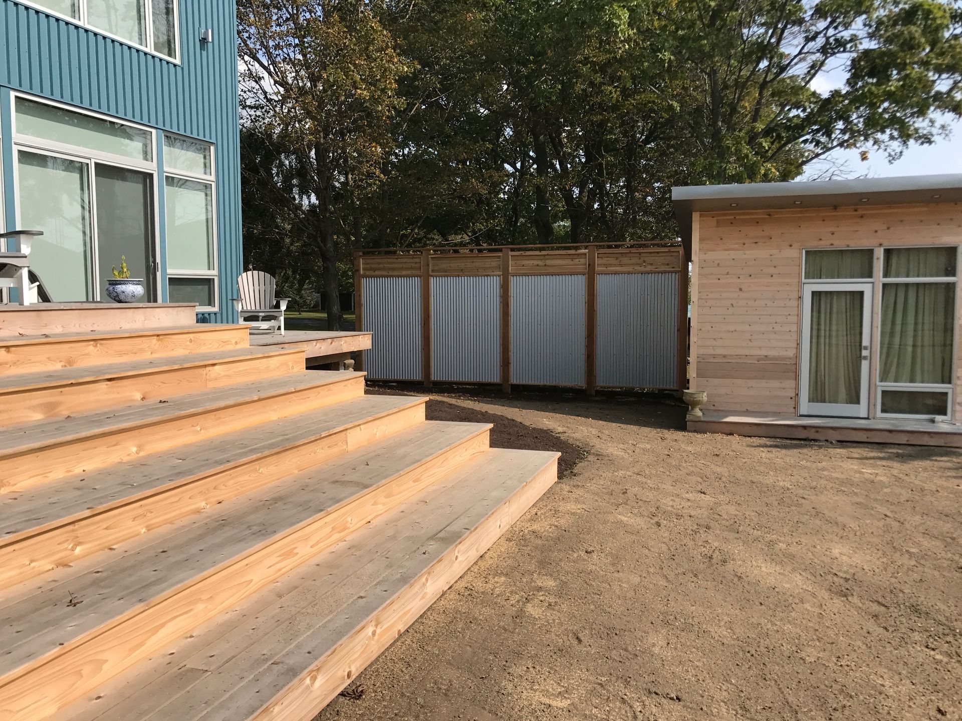 A wooden deck with stairs leading up to a house