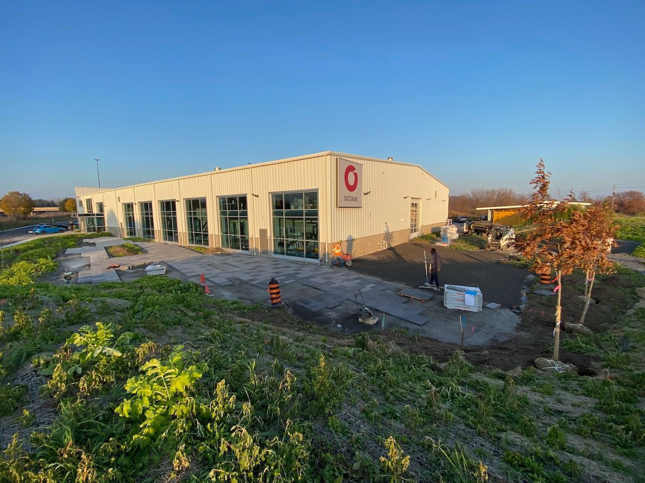 An aerial view of a building under construction in a field.