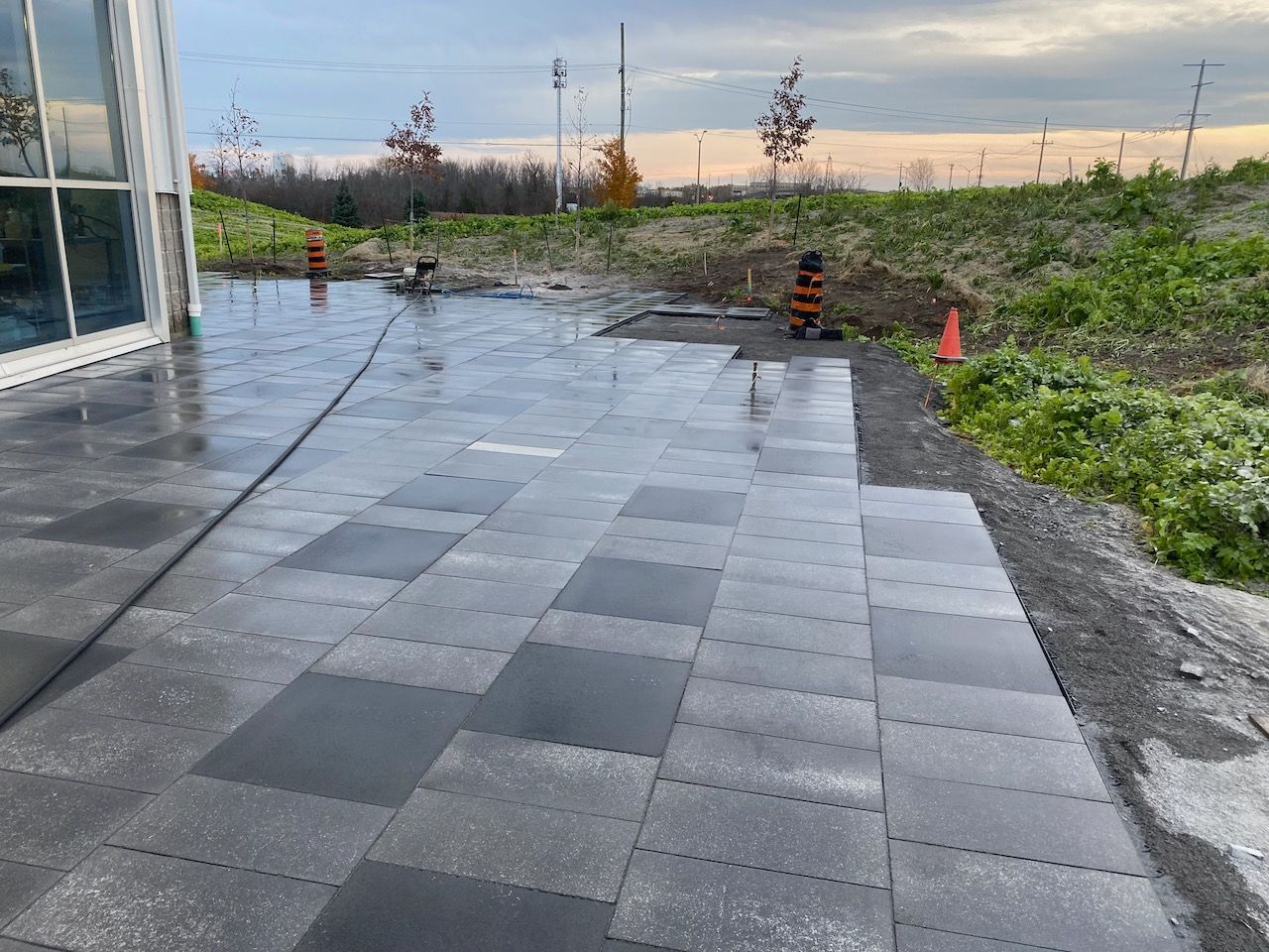 A patio with a hose attached to it is being cleaned.