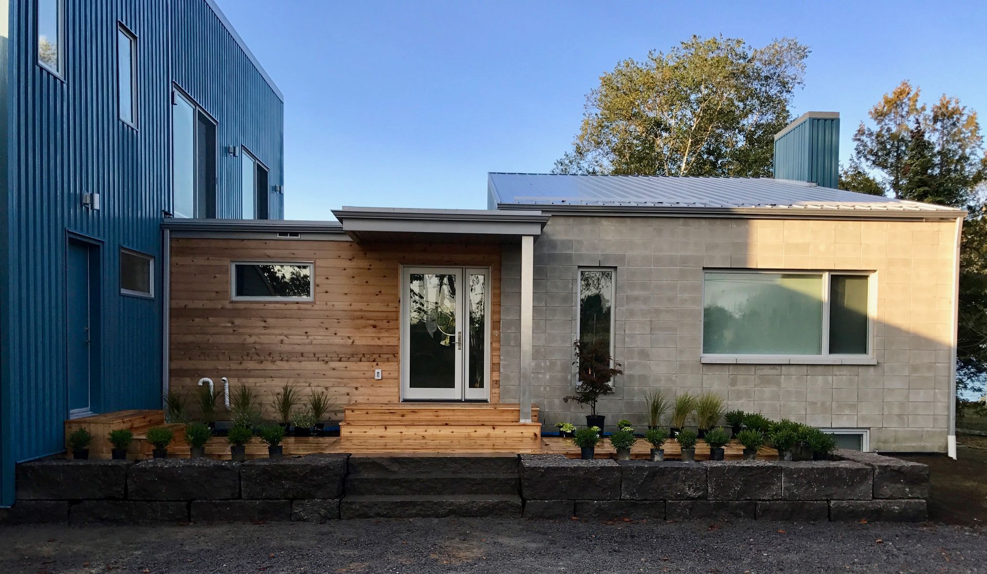 A house with a blue building in the background