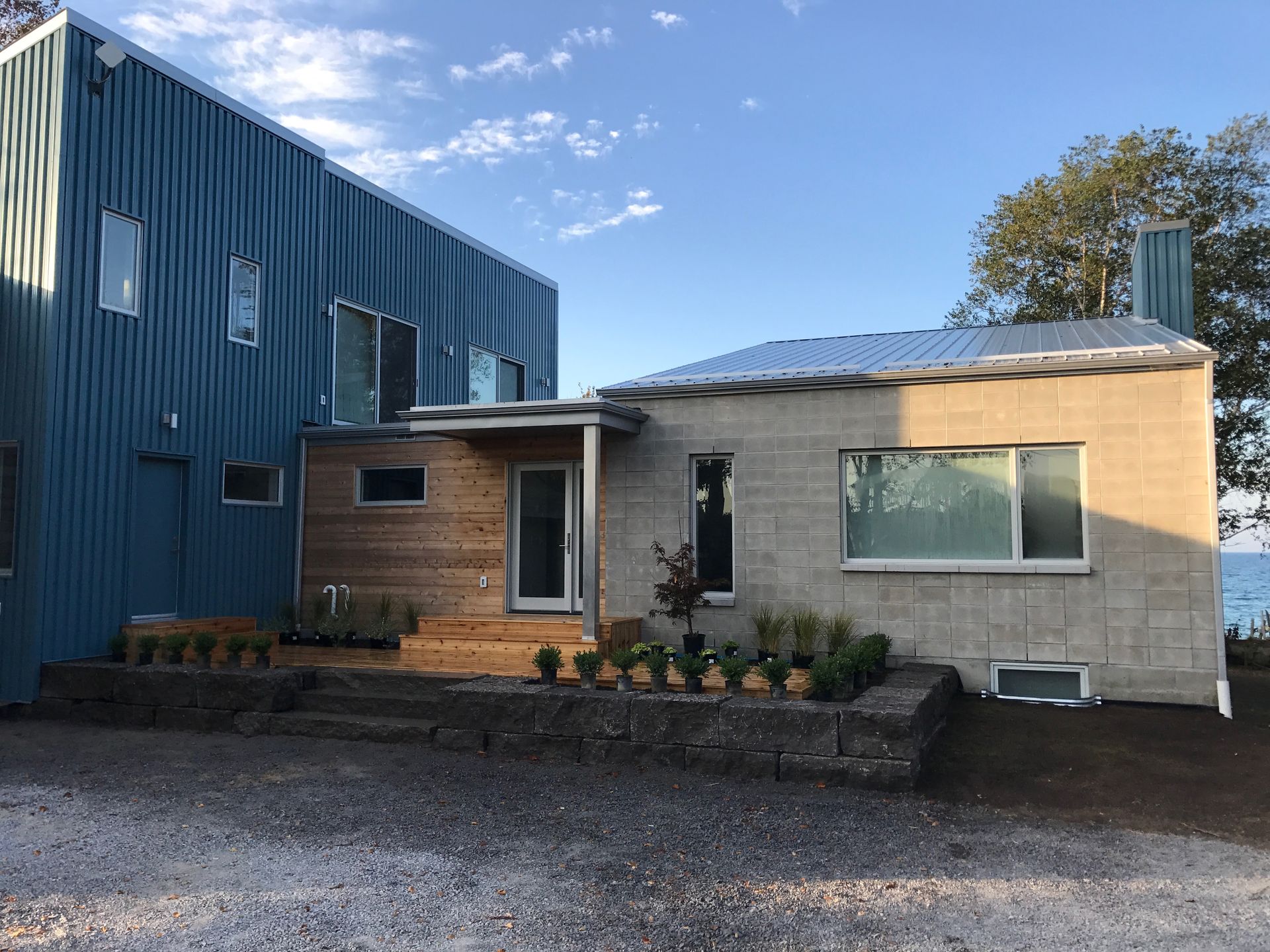 A house with a blue building and a brick building next to it.