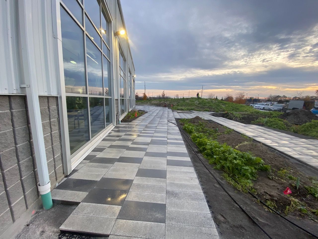 A walkway leading to a building with a lot of windows.