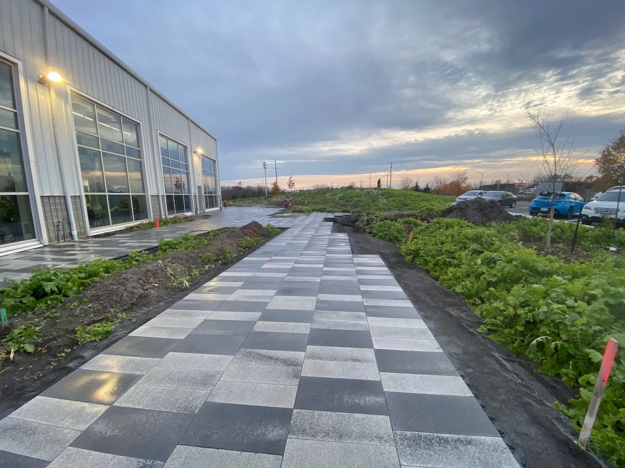 A brick walkway is being built in front of a building.