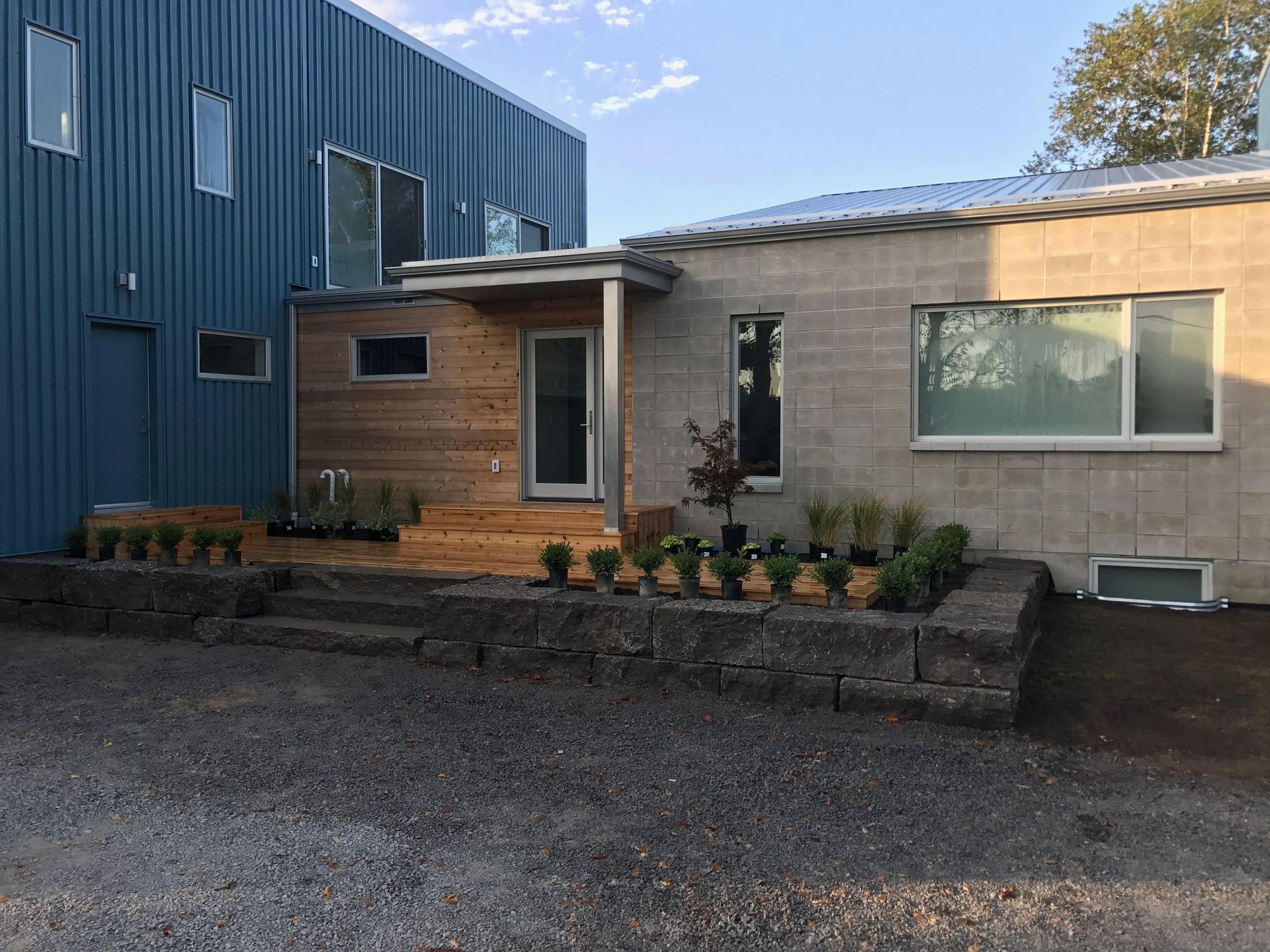 A brick house with a blue building in the background