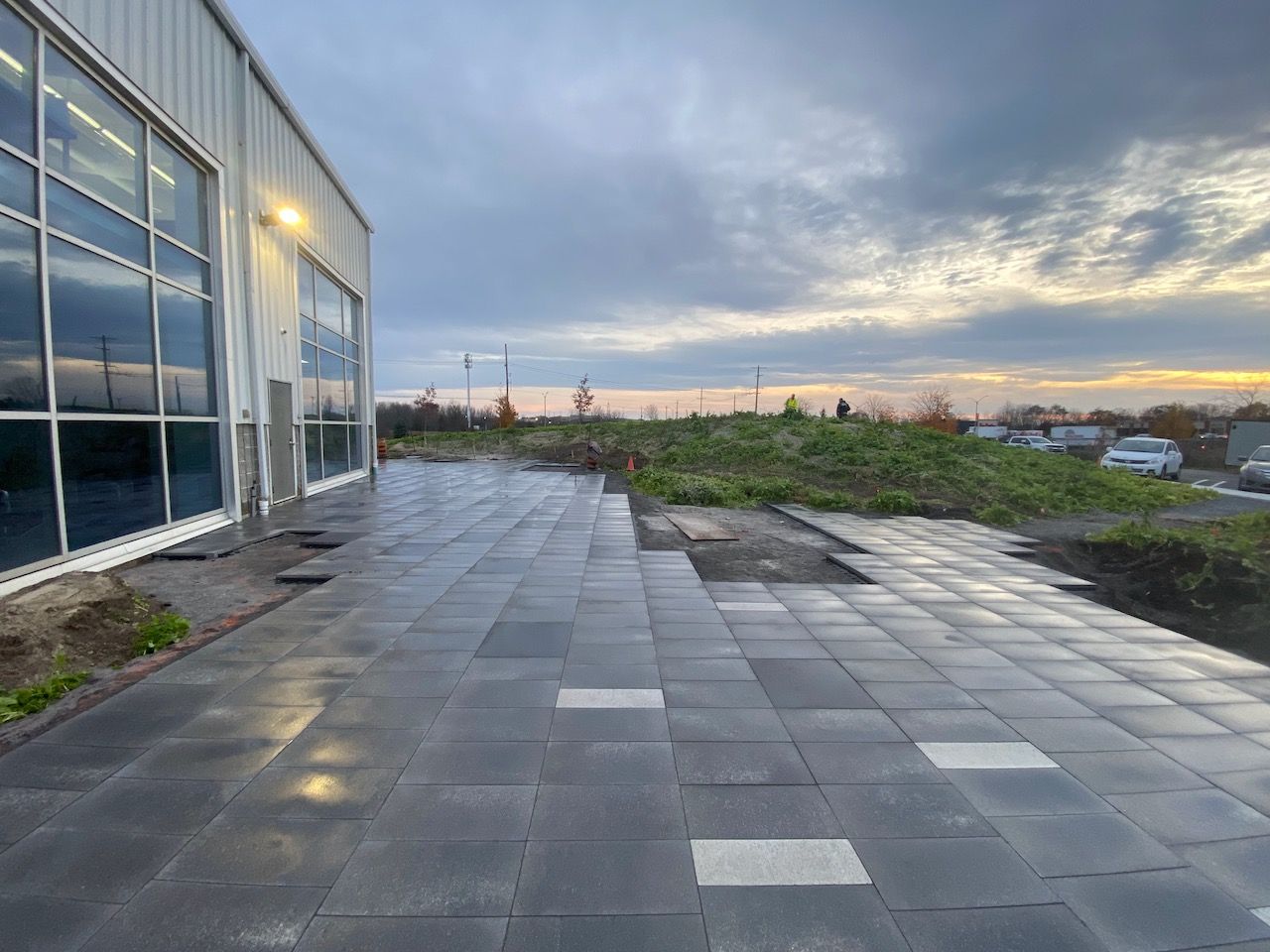 A large building with a lot of windows and a patio in front of it.