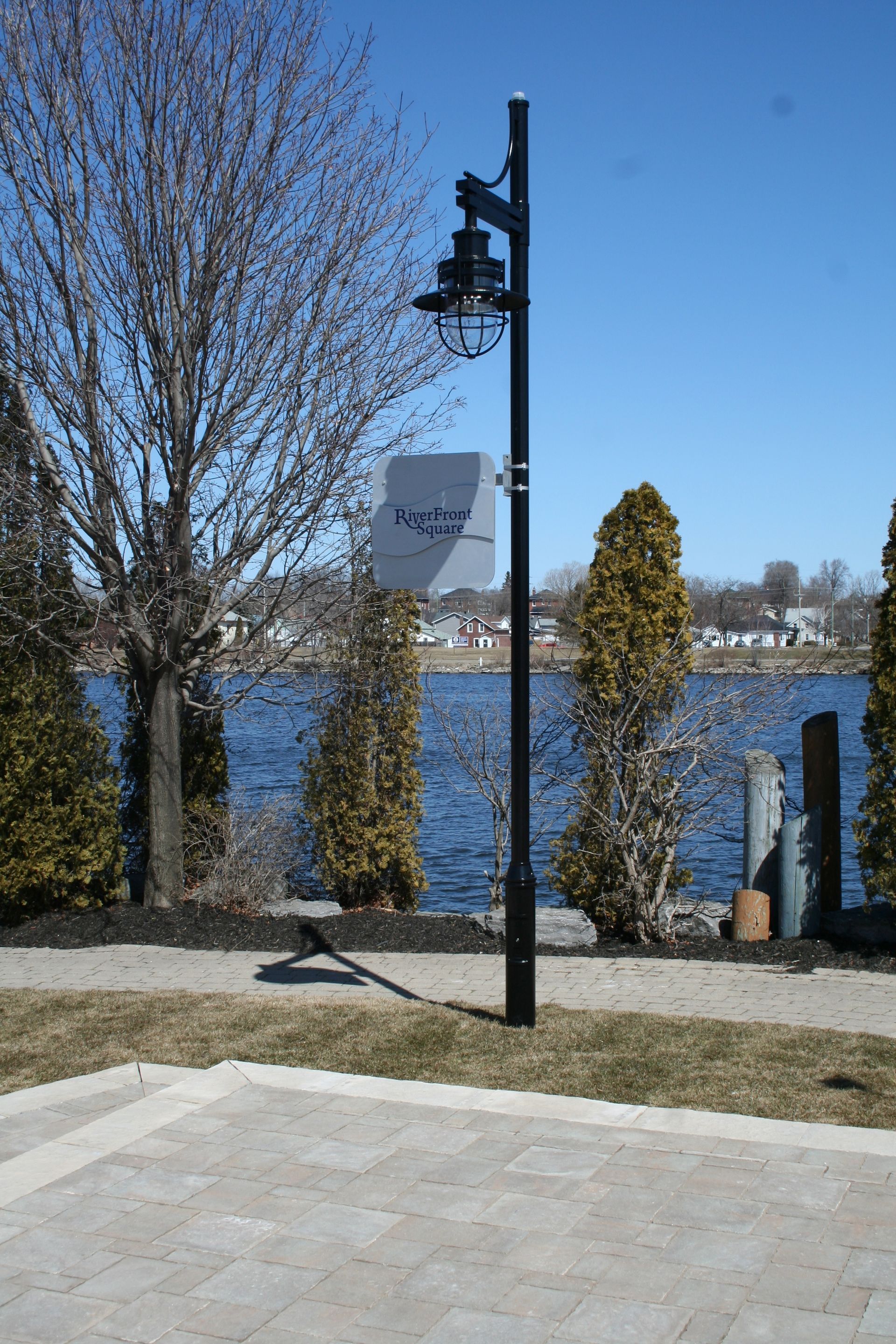 A lamp post in front of a body of water