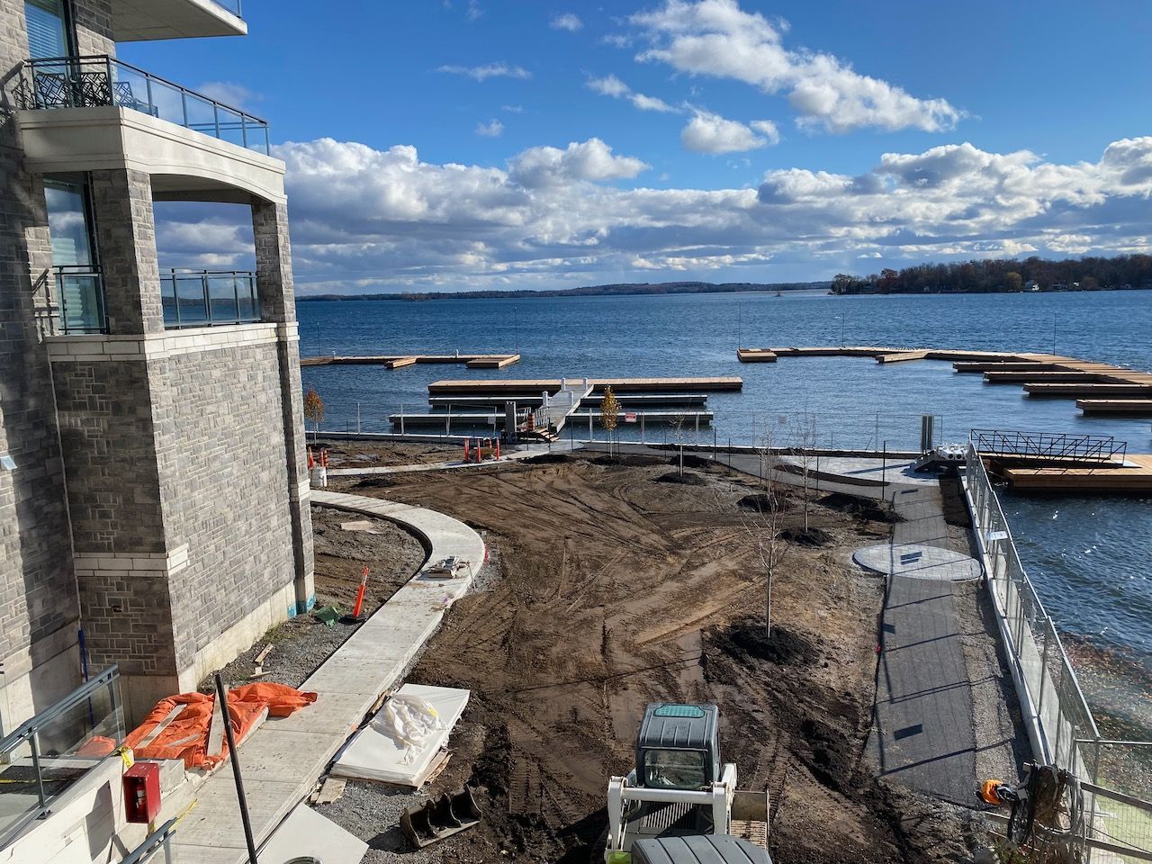 A large house is being built next to a body of water.