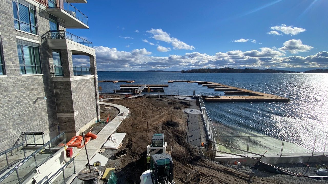 A large building is sitting next to a body of water.