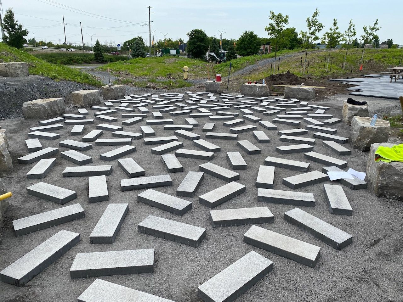 A bunch of bricks are laying on the ground in a circle.