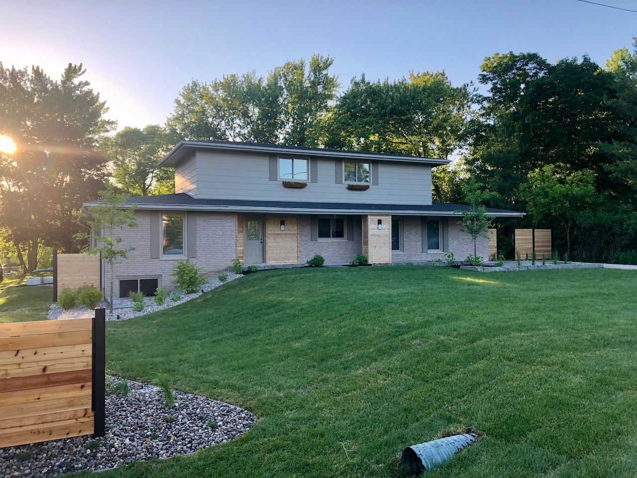 A house with a large lawn in front of it