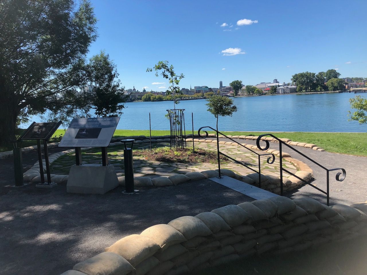 Stairs leading up to a lake with a sign in the foreground