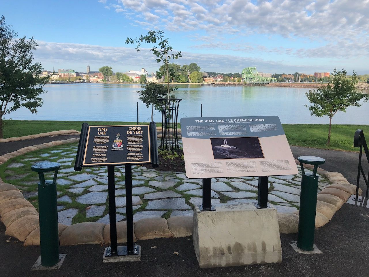 A couple of signs sitting in front of a lake