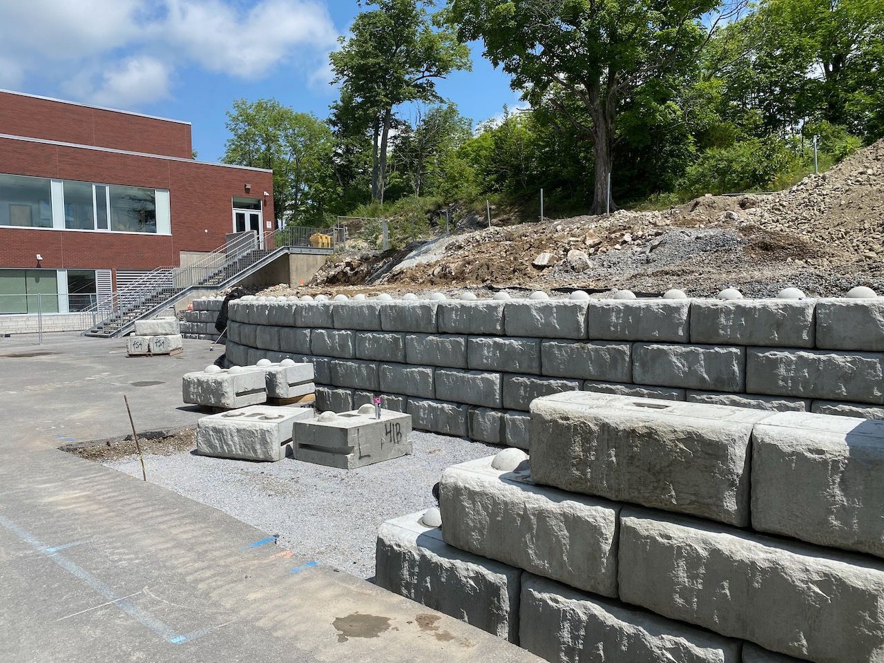 A brick wall is being built in front of a building