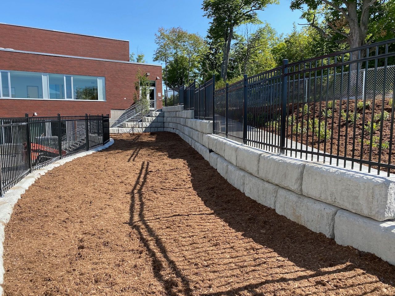 A brick building with a fence surrounding it