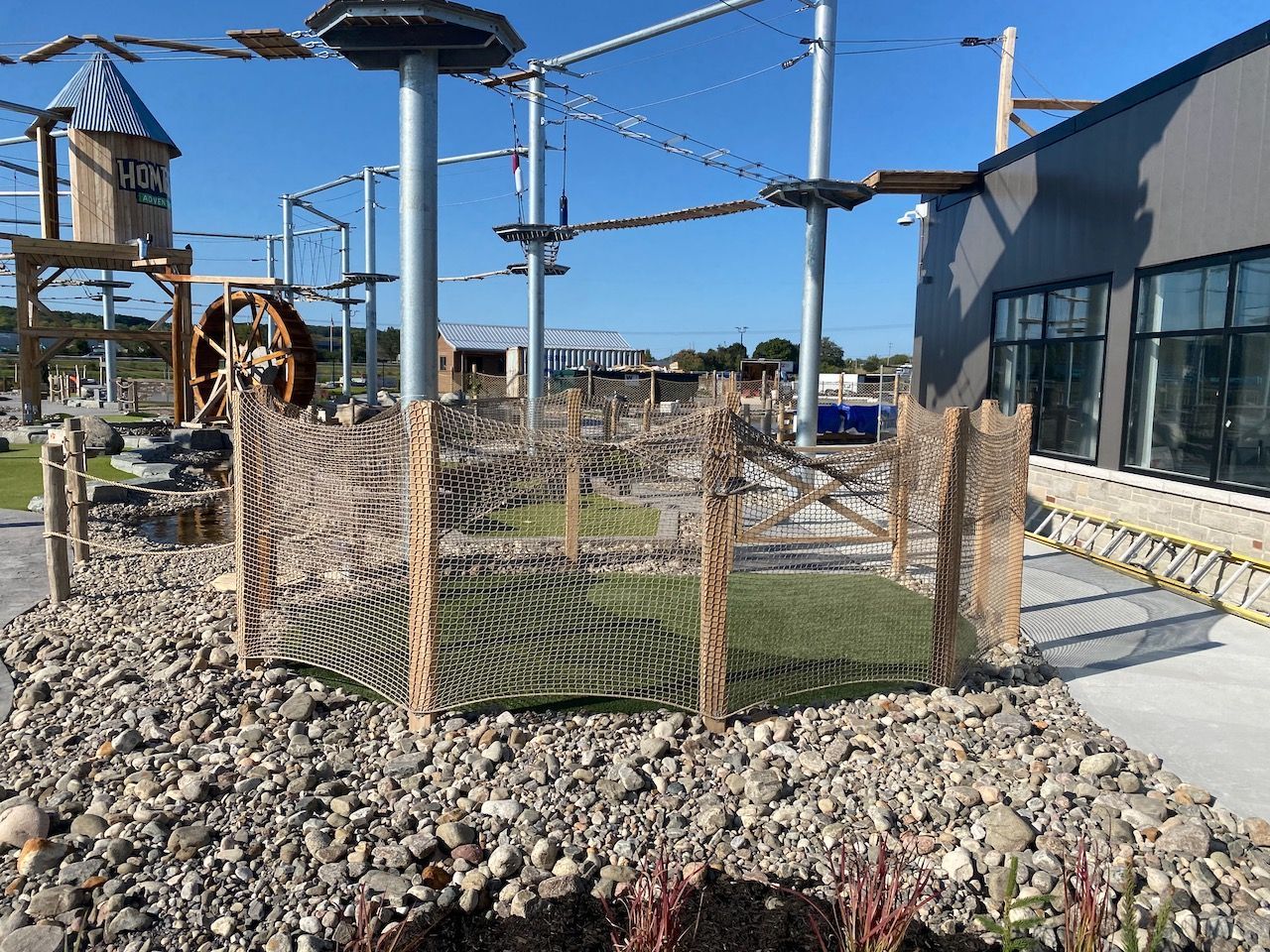 A ropes course is being built in front of a building.