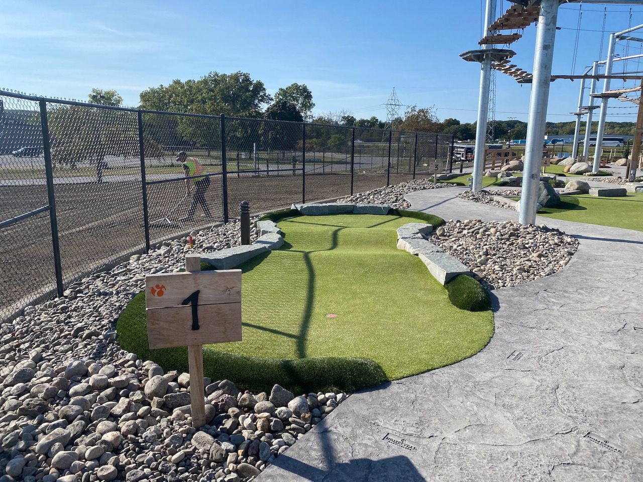 A small golf course with a sign that says 1 on it.
