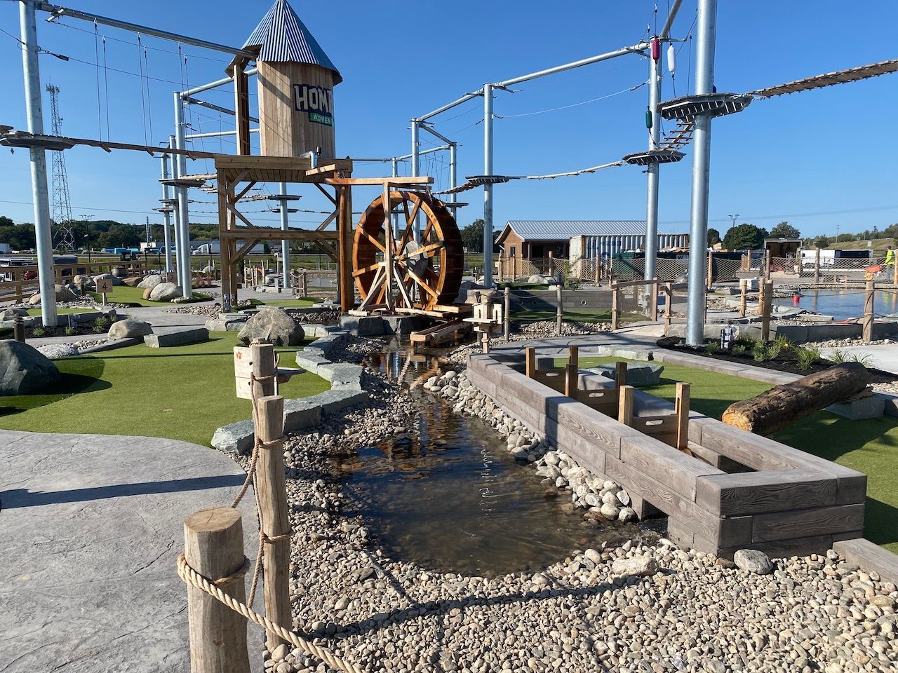 There is a water wheel in the middle of the park.