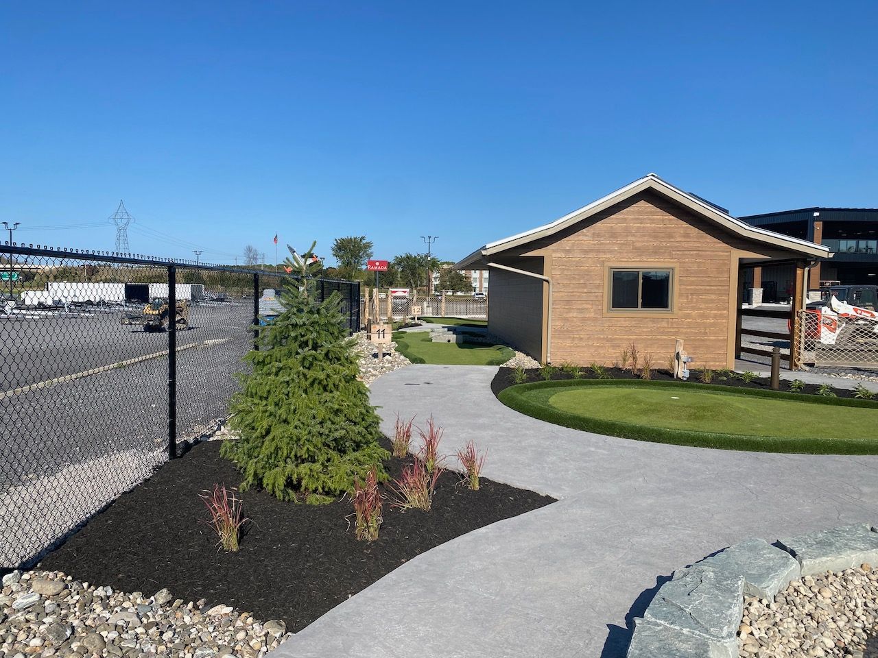 A small brick building with a fence around it
