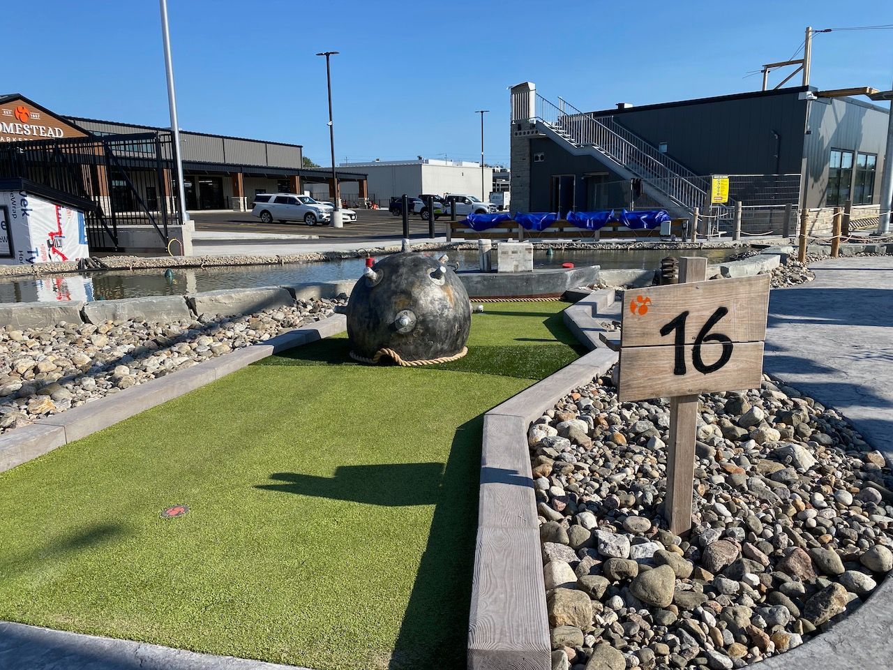 A golf course with a sign that says 16 on it.