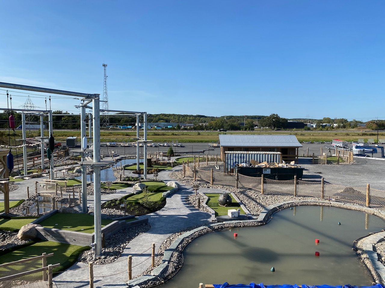 An aerial view of a mini golf course with a pond in the middle.