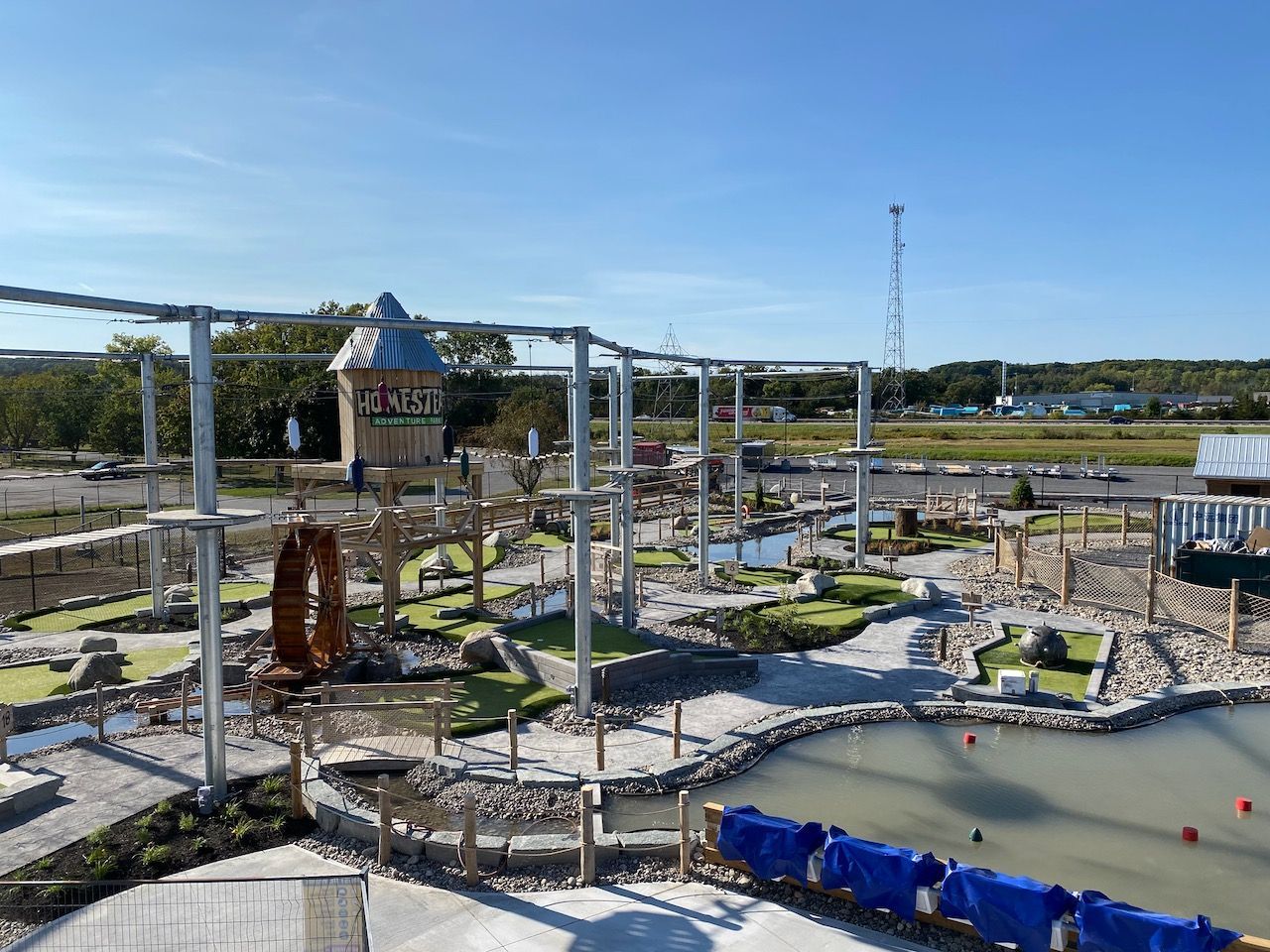 An aerial view of a park with a water slide and a ropes course.