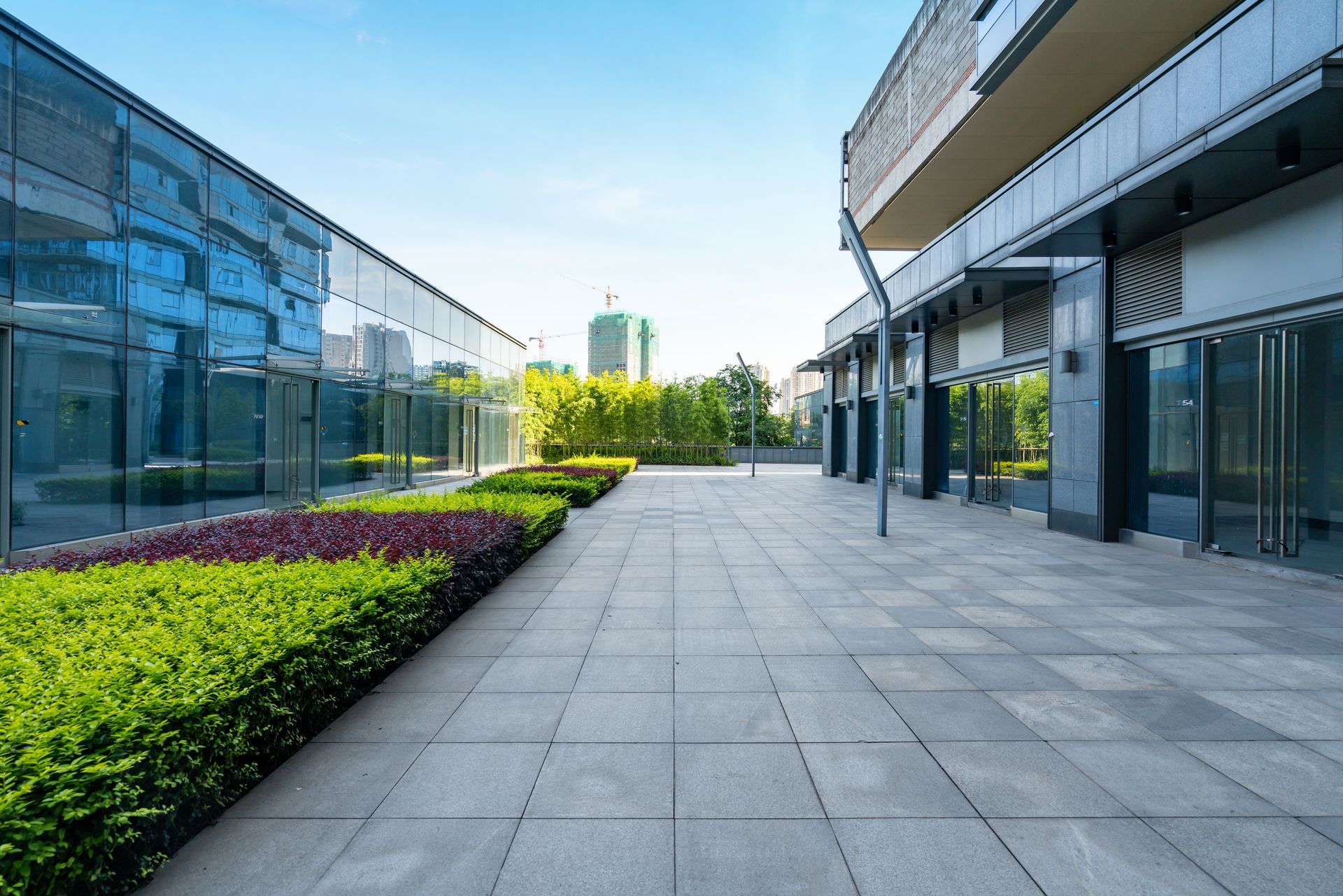 There is a concrete walkway between two buildings.