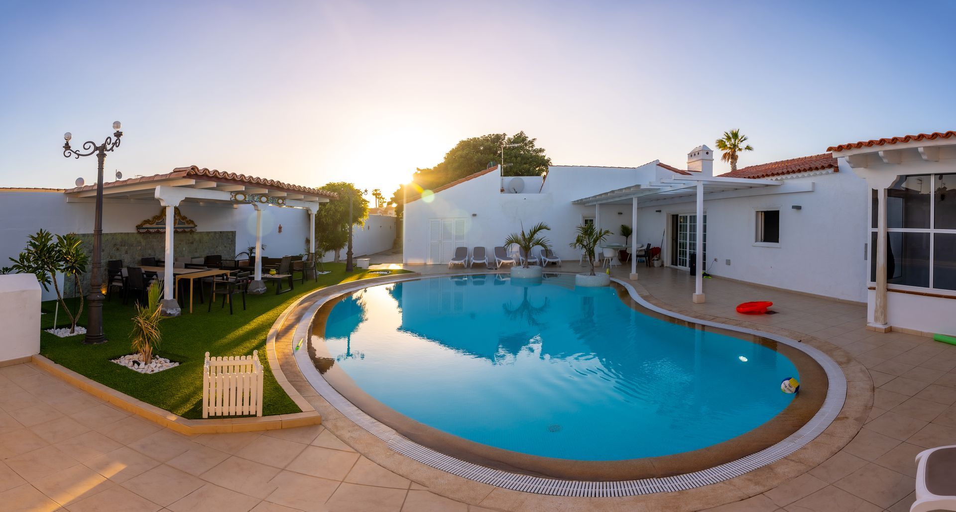 A large swimming pool in the backyard of a house