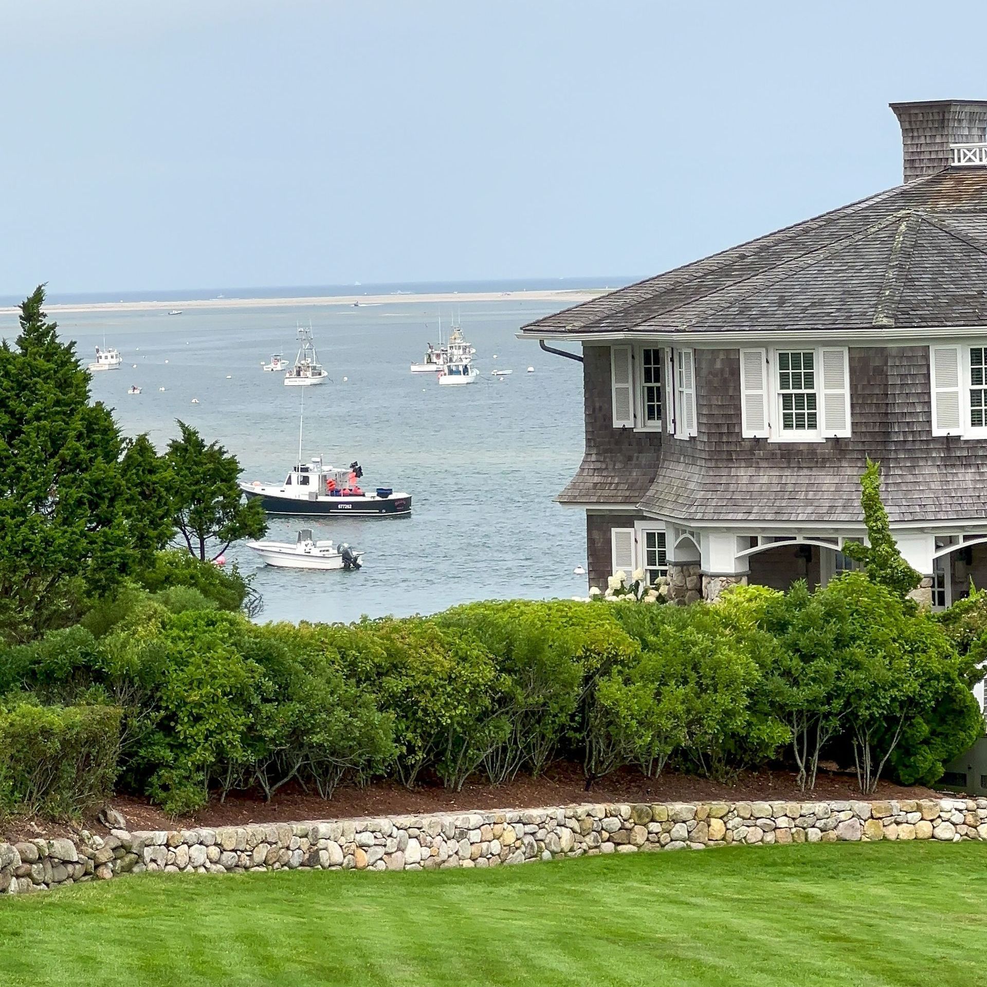 A house with a view of the ocean and boats in the water.
