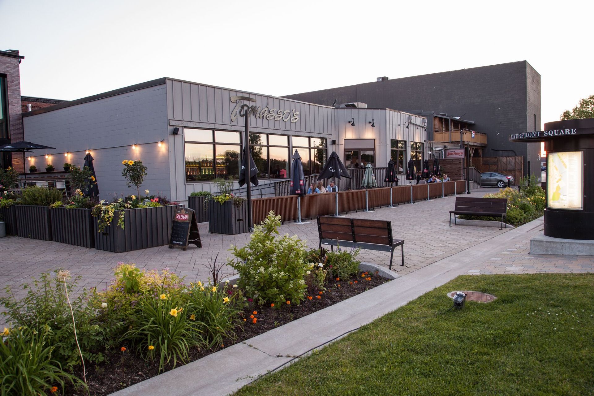 A large building with a lot of windows and a patio area in front of it.