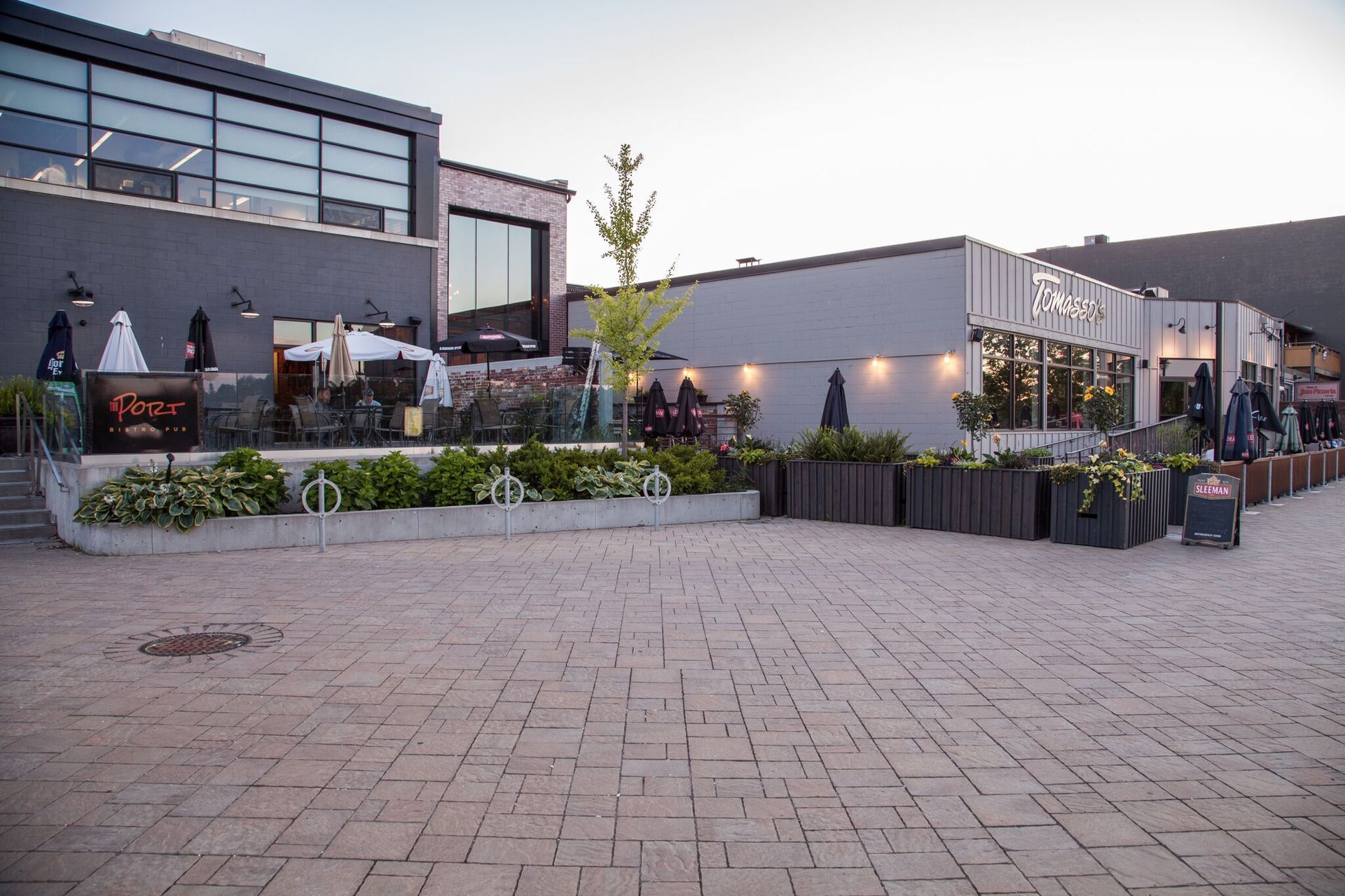 A large building with a lot of windows and a brick walkway