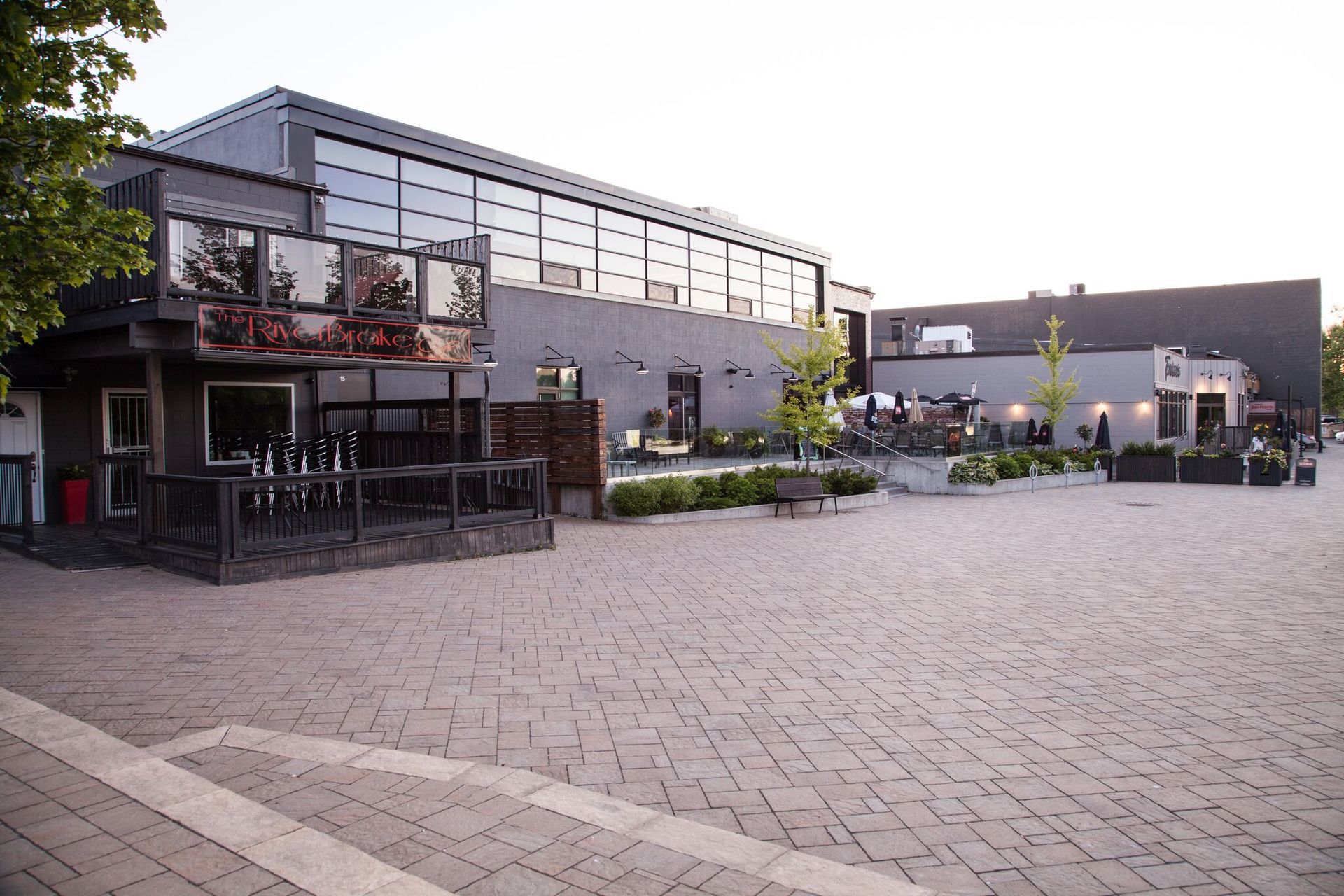A large building with a lot of windows is surrounded by bricks