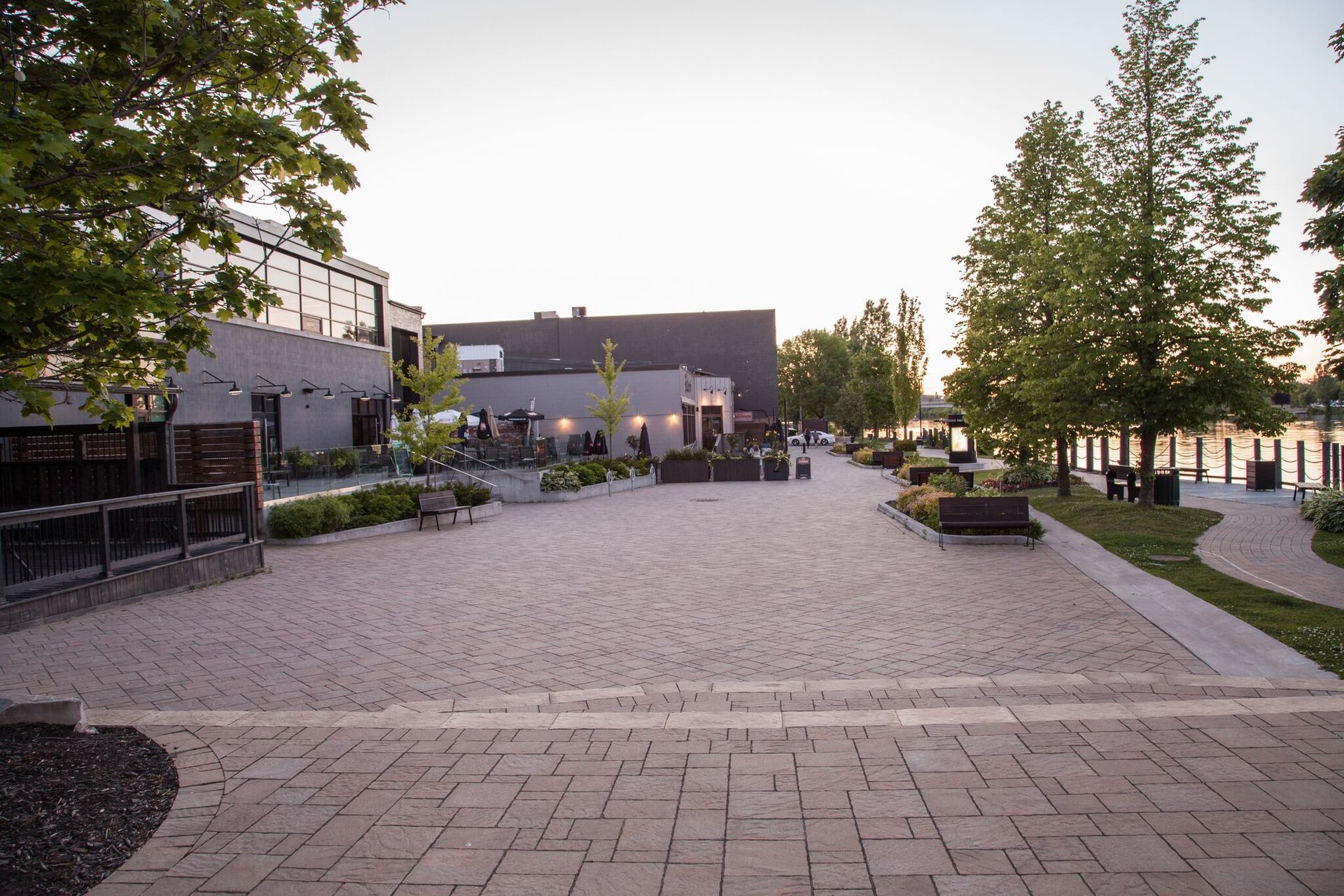 A brick walkway with a building in the background