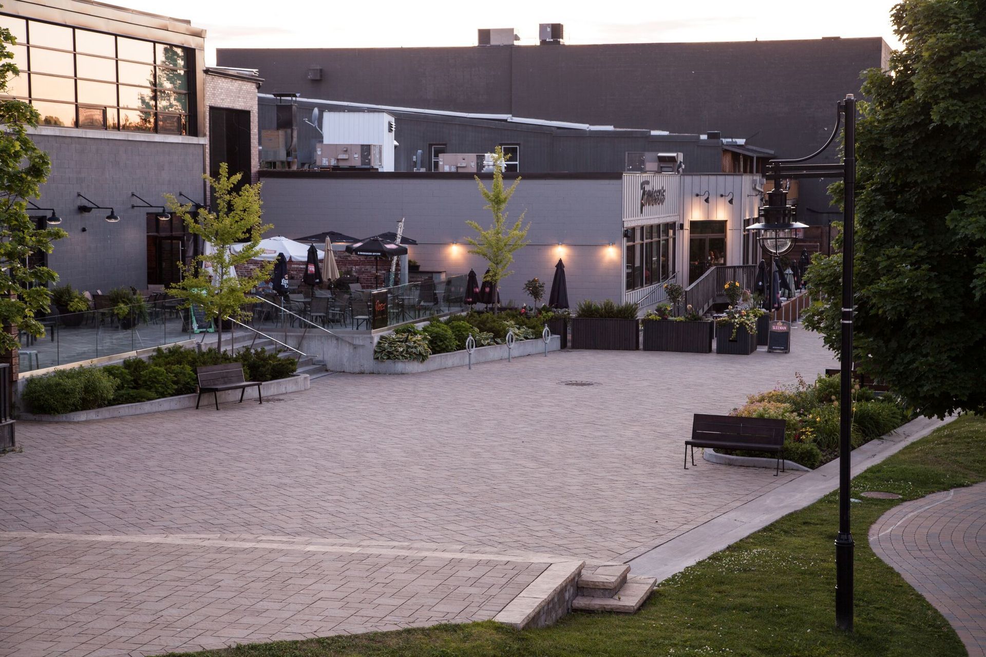 A large building with a lot of windows and a brick walkway