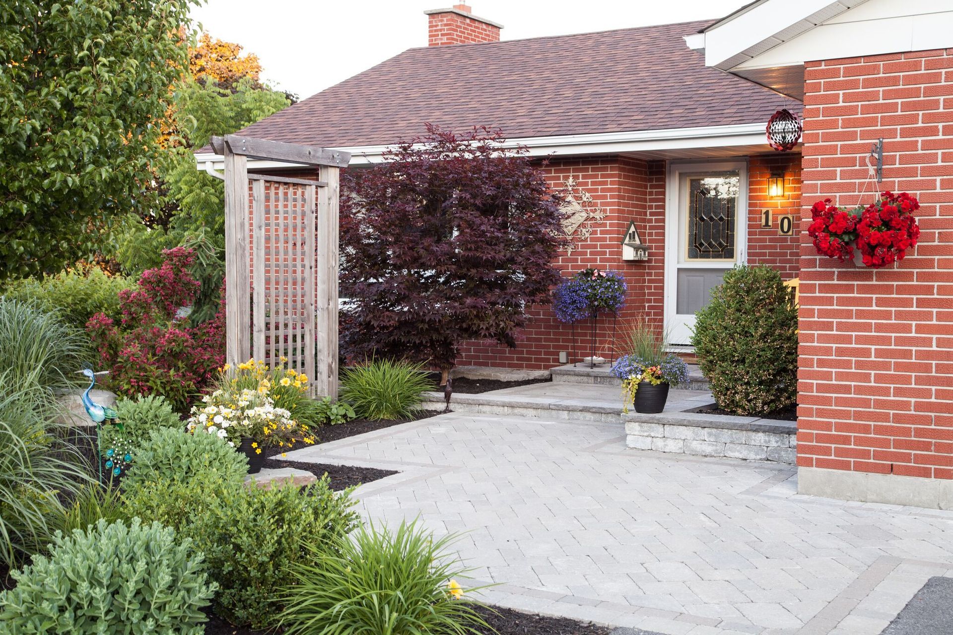 A brick house with a walkway leading to the front door