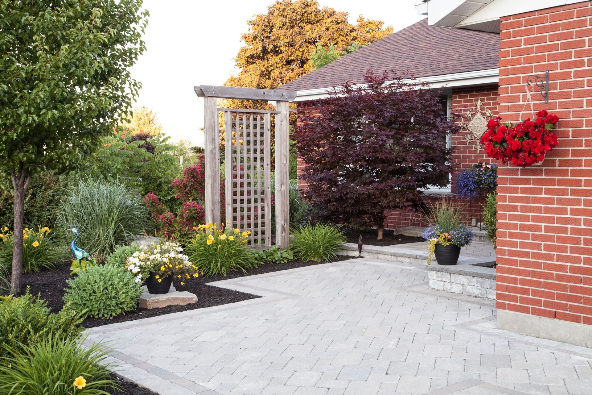 A brick house with a garden in front of it