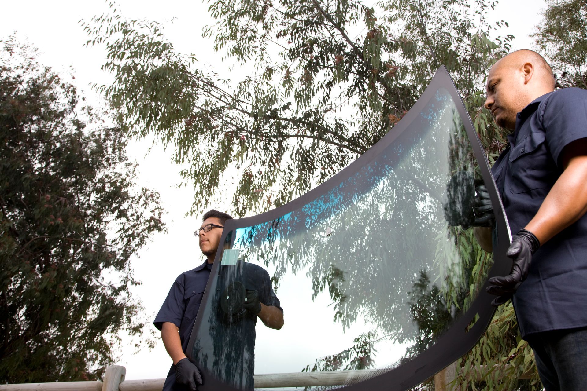 Specialists working on auto glass replacement services.