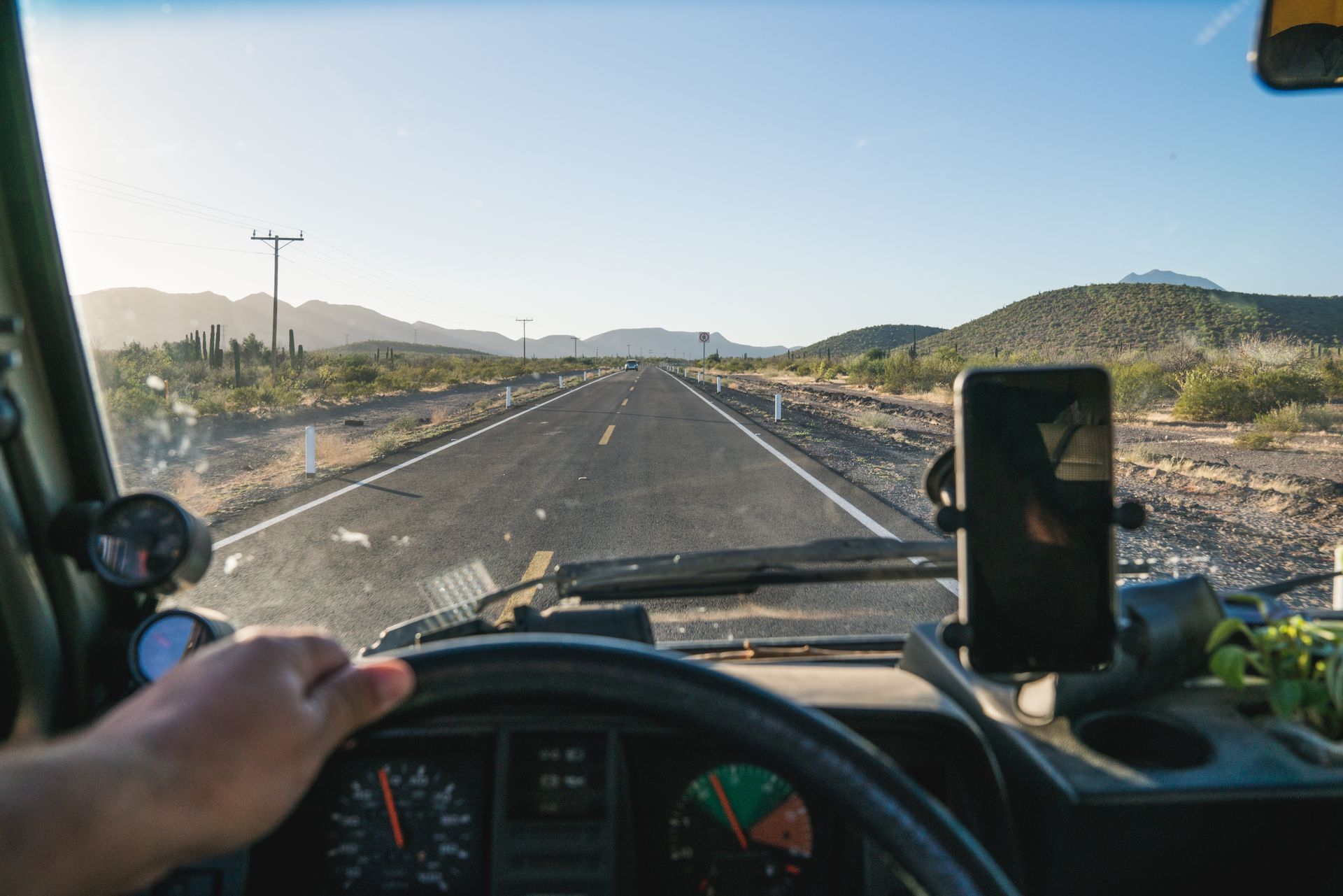 Point-of-view image of a person driving an RV, looking at the road through the windshield.