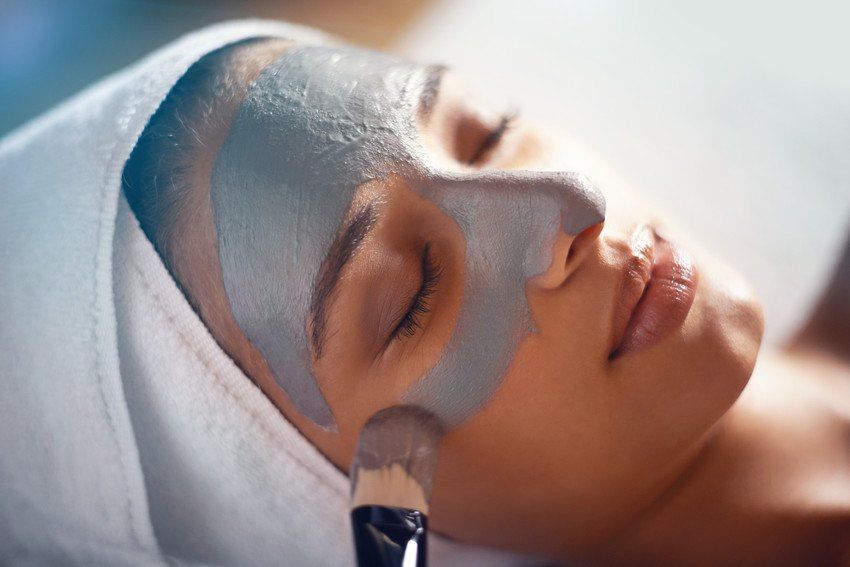 Shot of a young woman enjoying a facial treatment at a spa